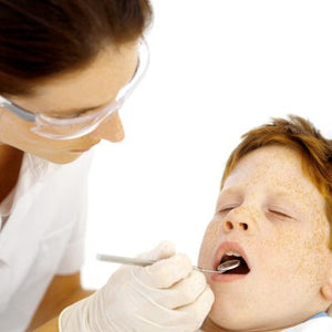 dentist checking child's teeth