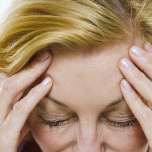 woman with ahnd son forehead