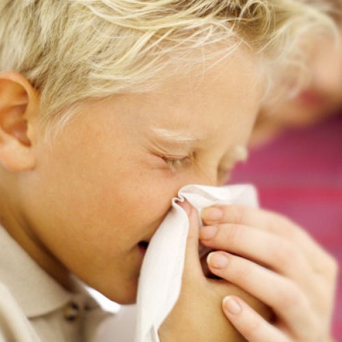 boy blowing nose